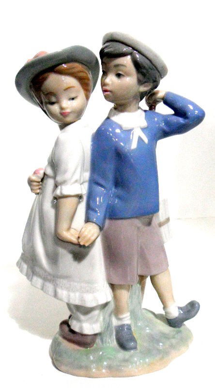 Lladro Spanish Porcelain Puppy Love Figurine #1127: Retired Lladro Puppy Love Figurine #1127. This pretty Lladro figurine features a young boy and a young girl holding hands. Lladro logo on bottom. Comes with original box. Made in Spain. Measures 10 1/