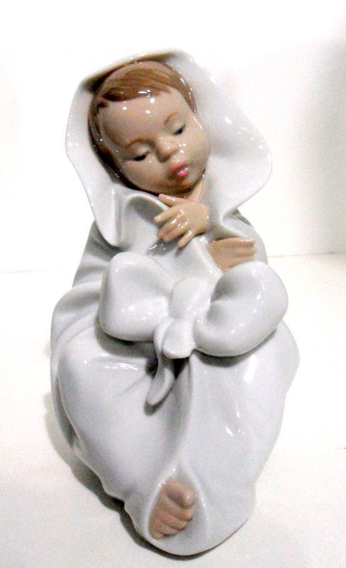 Nao by Lladro - All Bundled Up #1340: Nao by Lladro - All Bundled Up #1340. Handmade in Spain by Lladro. Comes with original box. Measures 7" high x 3.5" wide. Shipping within the continental US is $30 plus Required insurance. For interna