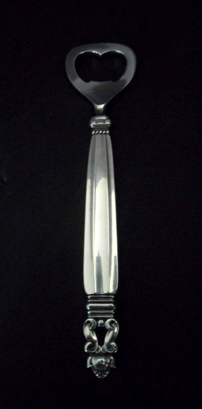Georg Jensen Sterling Silver Acorn Bottle Opener: Georg Jensen sterling silver bottle opener in the Acorn pattern. Marked Georg Jensen and Sterling Denmark. The hand is sterling silver while the bottle opener is stainless steel. 6 1/2"L. Shipping wit