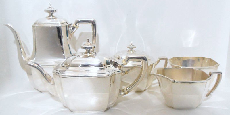 5pc. Tiffany & Co. Sterling Hampton Tea Set: Sterling silver tea service by Tiffany & Co. in the Hampton pattern. This set includes 5 pieces: Coffee pot, teapot, creamer, covered sugar bowl, and waste bowl. The two tea pots have ivory heat guard