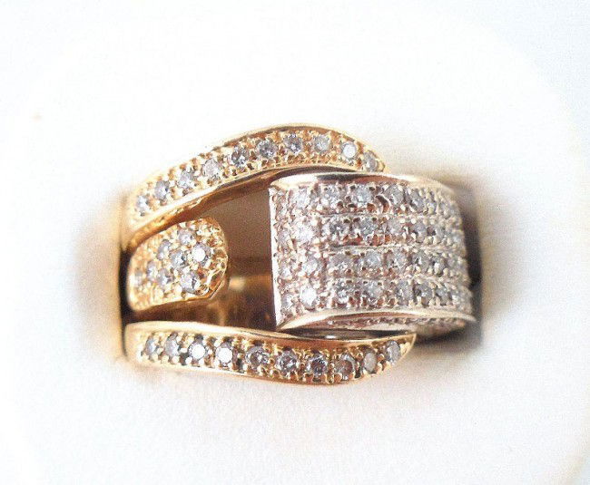 14Kt. Two Toned Diamond Ring: 14Kt. Two toned diamond buckle designed ring. This ring contains a total of approx 1.50Cts in diamonds having a overall VS clarity & I color. Ring size 6 1/2 & weighs 8.90dwt - 13.89g. Shipping within