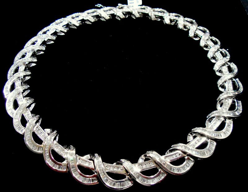Contemporary 18K WG & Baguette Diamond Necklace: 18Kt. White gold contemporary designed diamond choker necklace. This necklace contains a total of approx 30.50Cts in round & baguette diamonds. All baguette diamonds are uniformly set in a tapering ge