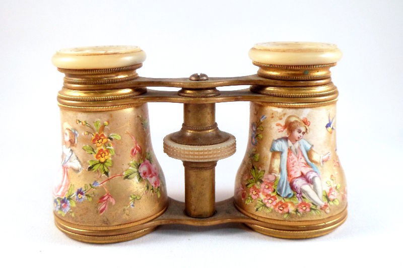 French Mother of Pearl and Enamel Opera Glasses: French mother of pearl and enamel opera glasses by Lemaire, Paris. Hand painted enamel covering depicts a maiden on one side and a young man on the other images of flowers, birds, and musical instrume