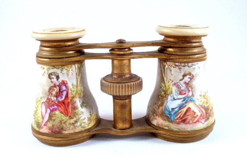 French Mother of Pearl and Enamel Opera Glasses: French mother of pearl and enamel opera glasses by Lemaire, Paris. Hand painted enamel covering depicts a maiden on one side and a young man on the other images of flowers and trees are featured throu