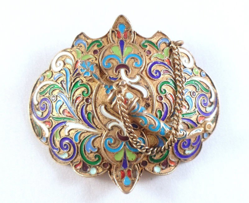 Russian Silver & Enamel Pin/Belt Buckle: Russian silver & enamel pin/belt buckle. The piece is covered in a gold wash, with beautiful colored enamel decorations. A small sword, which is attached by a chain, can come in and out of a holster o