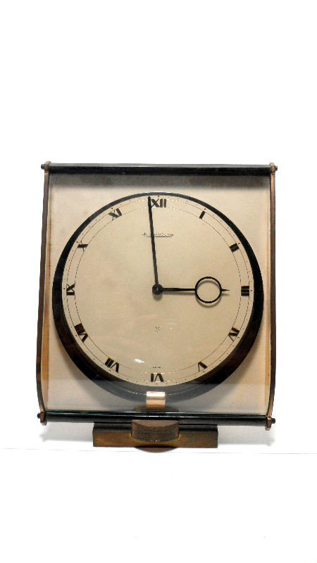 Jaeger-LeCoultre Desk Clock: Jaeger-LeCoultre desk clock. Marked on the joint " A Mademoiselle Renee Boss 1925-1945 Grand Passage," and "Jaeger-LeCoultre" on the face. Measures 7 1/2"H.Shipping within the continental US is $35 pl