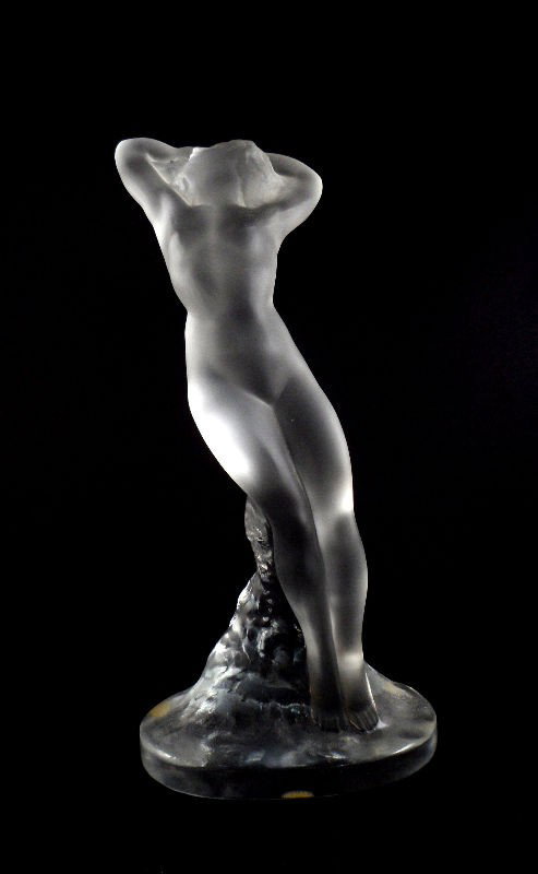 Lalique Crystal Nude "Danseuse" Figurine: Lalique crystal nude "Danseuse" figurine. The figure, supported by a molded mound of crystal, stands in a "S" curve position with her hands above her head. Engraved Lalique France on the bottom. Measu