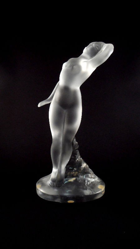 Lalique Crystal Nude "Danseuse" Figurine: Lalique crystal nude "Danseuse" figurine. The figure, supported by a molded mound of crystal, stands in a "S" curve position with one hand above her head. Engraved Lalique France on the bottom. Measur