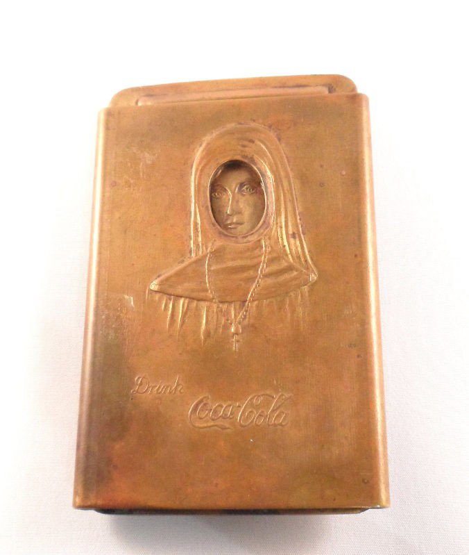 1915 Coca Cola Brass Belt Buckle: 1915 Coca Cola brass belt buckle. This unique piece feathers a brass case with a nun on the front and the line "Drink Coca Cola." A brass plate insert can be removed and reveals a naked woman, whose f