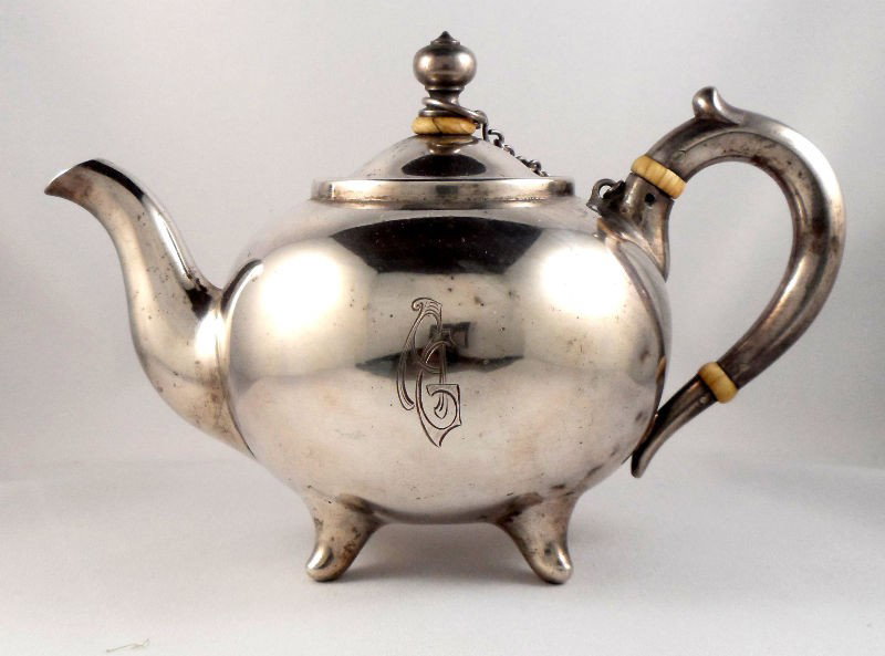 Russian Silver Teapot with Ivory: Russian silver teapot with ivory. Beautifully molded out of silver, this teapot has ivory heat guards to stop heat from reaching the lid and handle. Monogrammed with AG on the front. Bottom is stamped