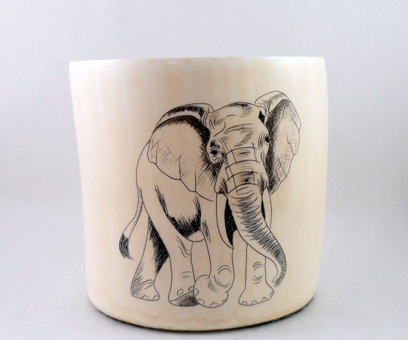 African Ivory Cup: African ivory cup with a pen work image of an elephant. The elephant is beautifully drawn, and the ivory is of a good quality. Measures 4" X 4".Shipping within the continental US is $30 plus required 