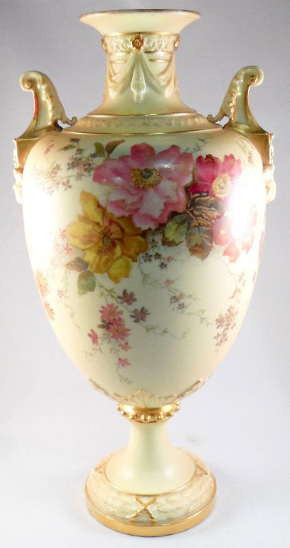 Royal Worcester Two Handled Vase: Fantastic quality Royal Worcester two handled blush ivory vase. The body being decorated with wonderful floral arrangements, the neck with pleated swags, and two acanthus leaf mounted handles. We coul