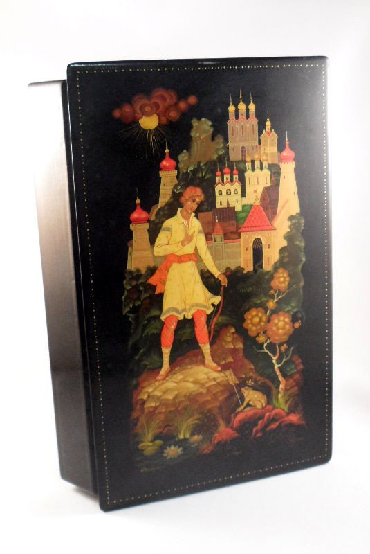 Rusian Black Lacquer box: Russian hand painted black lacquer rectangular shape box. Depicts a man in front of a frog with a castle in the background. Signed on bottom of painting "HB a Hyiuka" "Xoryia" " Mycarob". Measdures 1 