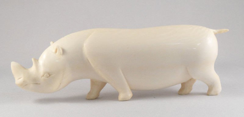 African Ivory Carved Rhinoceros: African ivory carved rhinoceros figurine. Measures 2"H X 6 1/4"L. Shipping within the continental US is $20 plus required insurance. No international shipping.