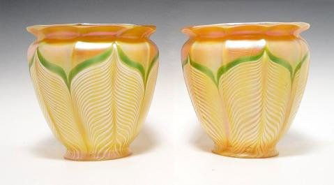 Quezal Iridescent Glass Shades (2): Pair of Quezal iridescent glass shades. Each pieces features a gold iridescent body with a white pulled feather effect; the pulled feathers have light green borders/ The shades are in a floral form, a