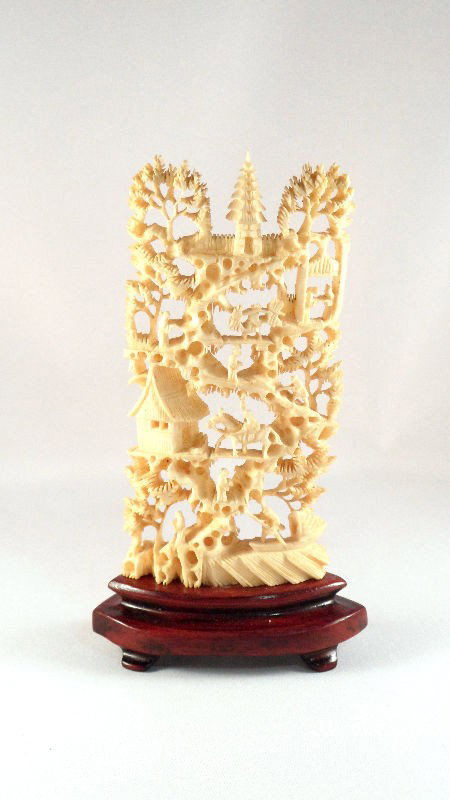 Chinese Ivory Carved Figural Screen: Chinese ivory carved figural screen. This finely detailed piece contains figures of peasants doing work, people riding horses, trees, and pagodas. Stand atop a wood base. Measures 5"H, base measures 1