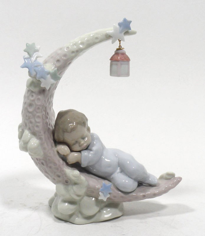 Lladro Spain Heavenly Slumber Figurine #6479: Lladro Spain Heavenly Slumber figurine #6479 featuring a small boy sleeping on the moon. Comes with original box. Issued in 1997. Sculptor is Antonio Ranom. Measures 7"H X 6"W. For Domestic and intern