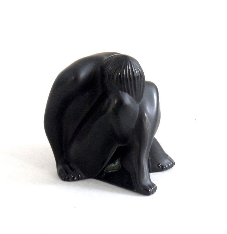Lalique Crystal Figure "Nude Venus" in Black: Lalique crystal figurine of a small nude Venus in black crystal. The figurine is of a sitting woman with her head down between her crossed legs. Marked Lalique France on the bottom. The piece comes in