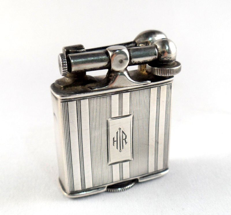 Vintage Clark Sterling Silver Lift-Arm Lighter: Vintage Clark sterling silver lift-arm lighter. Monogrammed on the front. The bottom is marked "Clark Lighter Pat July 27, 1925," and Sterling. Weight: 1.3t oz. Measures 1 3/4" X 1 1/4". For Domestic