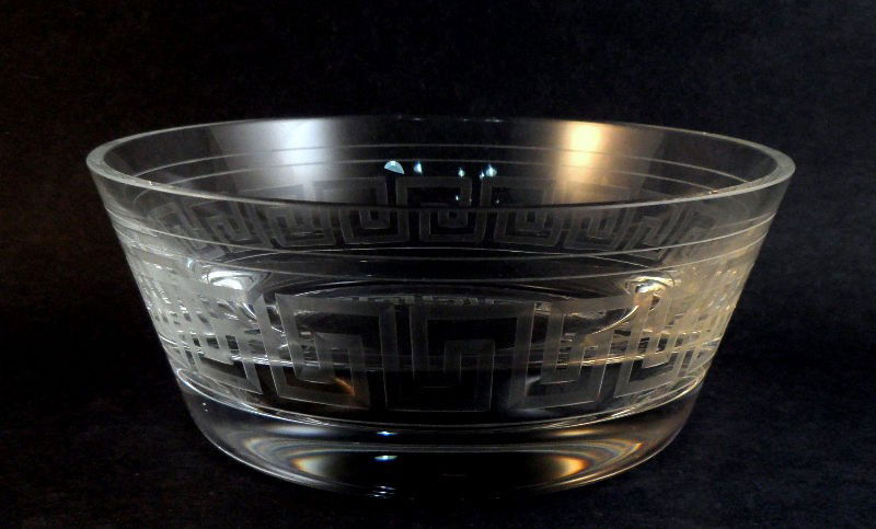 Versace by Rosenthal Glass Bowl: Versace by Rosenthal glass bowl. The small bowl has the standard Versace Greek Key pattern etched into it. Marked Rosenthal Versace on the bottom. Piece comes in the original box. Measures 5 1/2"D. Fo
