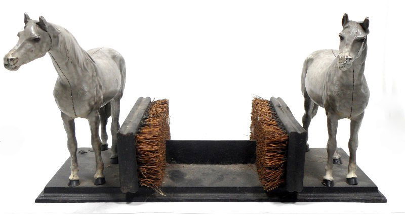Antique Equestrian Boot Scraper: Antique equestrian boot scraper. Two gray horses stand on either side of two brushes, which are used to clean boots. Measures 8"H X 16"W X 7"D. For Domestic and international shipping quotes please em