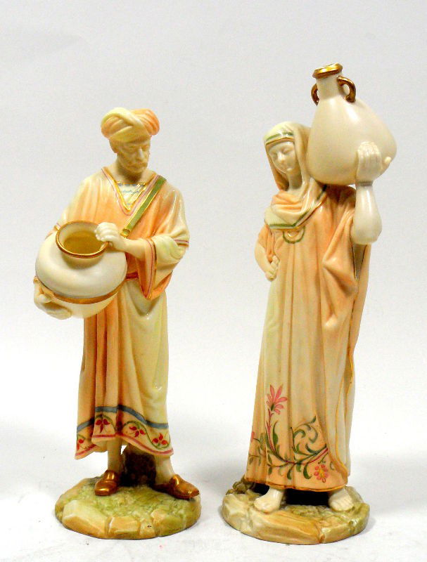 Royal Worcester Figurines "Cairo Water Carriers": Royal Worcester figurines entitled "Cairo Water Carriers." A man wearing a turban carries a large vessel and the female figure wears long robes and carries a two-handled vessel. The pieces are hand pa