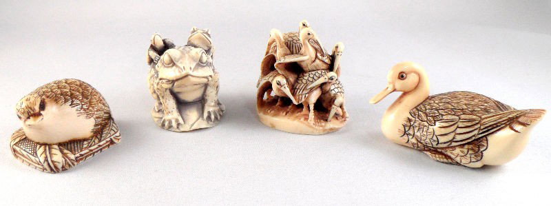 Chinese Ivory Carved Animal Nestukes (4): Chinese ivory carved set of 4 animal netsukes. The animals carved are a nesting bird, a duck, a group of frogs, and a flock grouping of birds. Each piece is signed on the bottom. Measurements vary fro