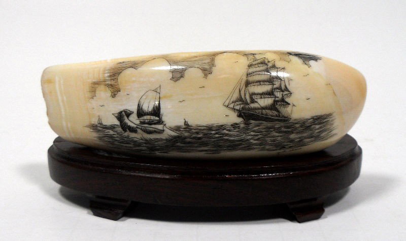 Chinese Etched Ivory Tusk: Chinese etched ivory tusk/tooth. Depicts a water scene with sailboats. Sits on a fitted wooden base. Very good condition. Measures 4 3/8" X 1 1/2" X 1", base measures 4 1/2" X 1 5/8" X 1 3/8". Signed 
