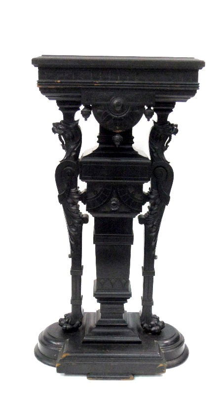 Antique Carved Wood Pedestal: Antique carved wood pedestal. Magnificently carved with two large gryphon's flanking the central plinth. The wood has been painted black to emulate ebony. Measures 40"H. For Domestic and international