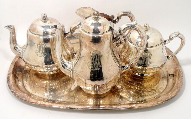 Christofle Silver Plate Tea Set (5pcs): Christofle silver plate 5 piece tea set. The set is comprised of a coffee pot, teapot, sugar bowl with lid, creamer, and tray. Each piece is monogrammed and impressed with the Christofle marks. Measur