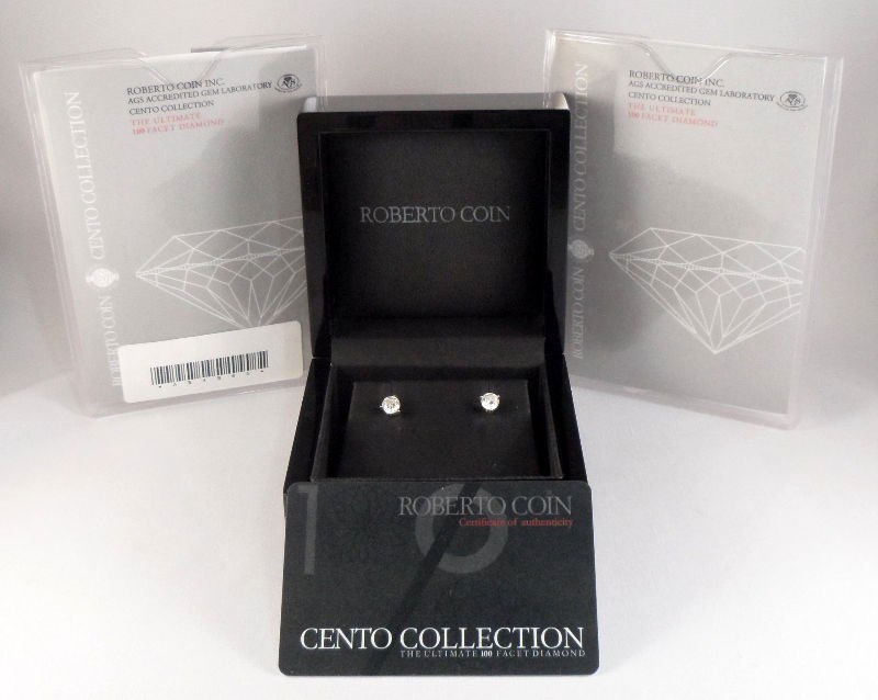 Roberto Coin Diamond Cento Stud Earrings: Roberto Coin diamond cento stud earrings featuring 18K white gold settings. Both diamonds have matching weight of 0.71 and 0.72ct, S/I clarity, color G. Each earring includes a hidden ruby, which is t
