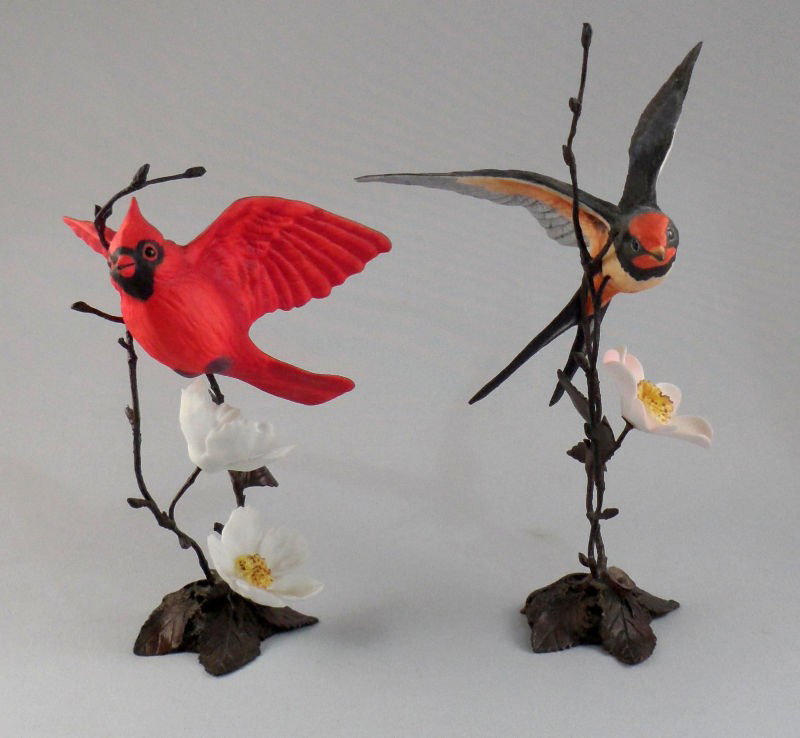 Royal Worcester Bronze Porcelain Bird Figurines (2: Royal Worcester bronze porcelain bird figurines featuring two life-like sculptures with exactly detail. One is a cardinal and the other is a barn swallow. Measures 5"H and 5 1/2"H respectively. For Do