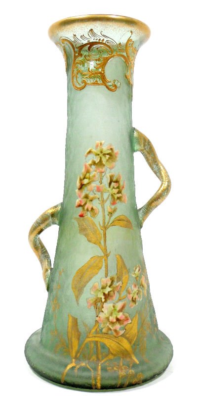 Mont Joye Glass & Gilt Vase: Mont Joye glass and gilt vase. The piece is crafted of a stunning green opaque glass and painted with gold leaves and beautiful pink flowers. A gold pattern lines the top rim of the vase. Two asymmetr