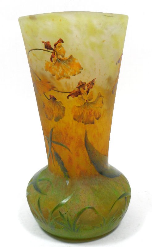 Rare Daum Nancy Cameo Glass Vase: Rare Daum Nancy cameo glass vase. This green and yellow glass vase is painted with stunning flowers and large detailed blades of glass. A fluted vase extends from a rounded base. Signed Daum Nancy in