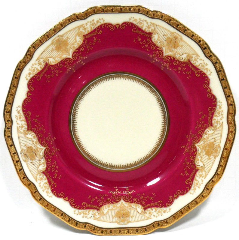 Black Knight Regina Porcelain Plates (16): Black Knight set of 16 plates in the Regina pattern. Each plates is decorated with a burgundy glaze, gold patterns throughout, and a gilt rim. The back of each plate is marked Black Knight, Registered