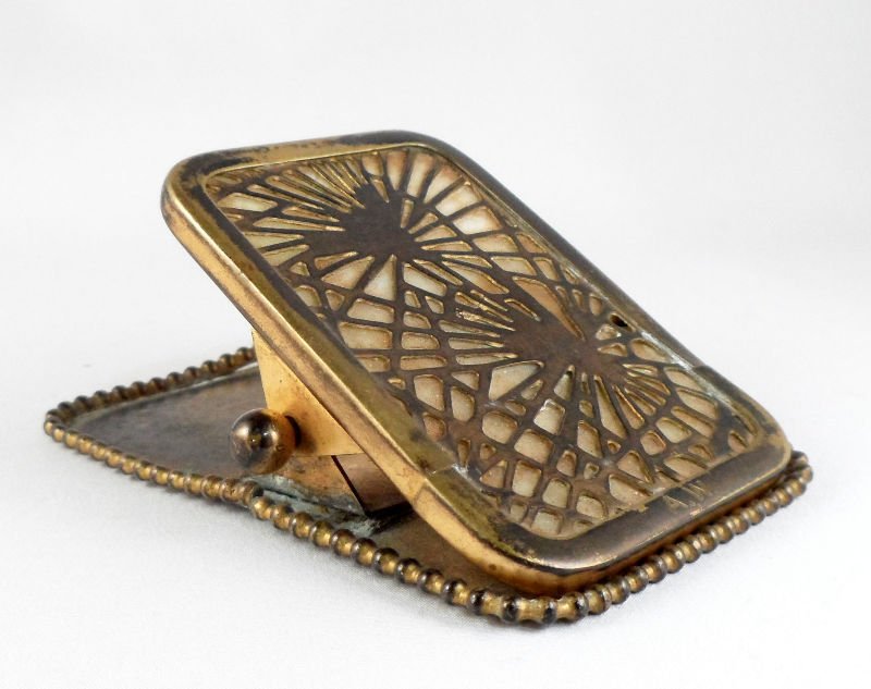 Tiffany Studios Pine Needle Bronze Paper Clip: Tiffany studios pine needle bronze paper clip with bone colored glass. Signed Tiffany Studios on bottom. Height 1 1/2" x 3 3/4" x 2 3/8". For shipping and required insurance quotes feel free to call R