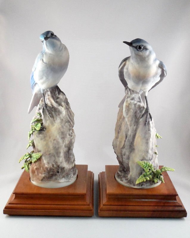 Royal Worcester Doughty Porcelain Mountain Bluebird: Pair of mountain bluebird figurines by Doughty for Royal Worcester. Figurines are set into wood bases. Measures 9 3/4" including base. For Domestic and international shipping quotes please email Ryan@