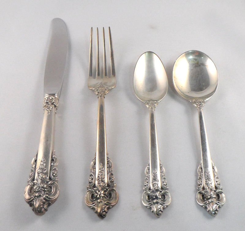 Wallace Grande Baroque Sterling Silver Flatware Set: Wallace grande baroque sterling silver flatware set. The set includes 4 knifes measuring 9", 3 forks measuring 7 5/8", 3 salad forks measuring 6 1/2", 10 teaspoons measuring 6 1/4", 4 cream soups 6 1/