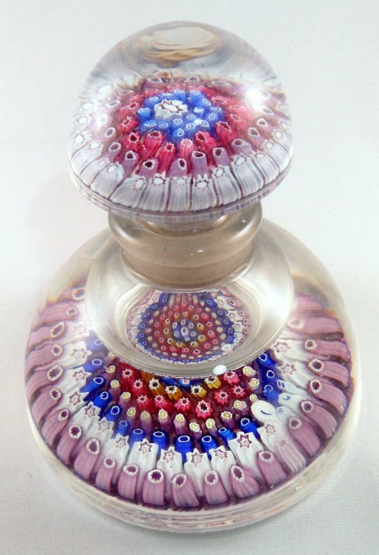 Millifiore Art Glass Paperweight Bottle: Beautiful millifiore art Glass paperweight bottle with multicolor design throughout. The height is 5.75 x 5 inches. For shipping and insurance quotes please call Ryan or Dave at Eagle Shipping Center 