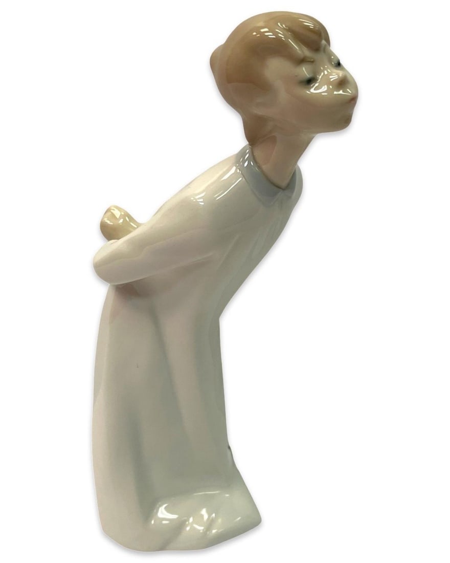 Lladro Boy Blowing Kiss Porcelain Figurine: Lladro Boy Blowing Kiss Porcelain Figurine measures H: 7 3/8"