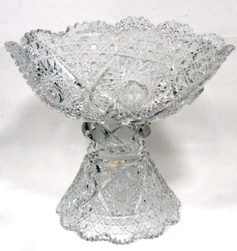Vintage Cut Crystal Footed Punch Bowl: Beautiful vintage cut crystal footed punch bowl with elegant cut crystal design. Measures approximately 12 1/4" x 11 5/8". This centerpiece would look great on any table. For shipping and insurance qu