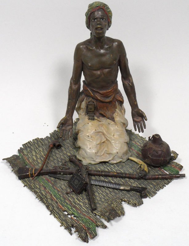 Bergmann Austrian Bronze Signed Figure: Austrian bronze signed Bergmann figure of a man on a carpet with weapons on it. Signed. Measures 8" high x 7" wide x 7 1/2" depth.