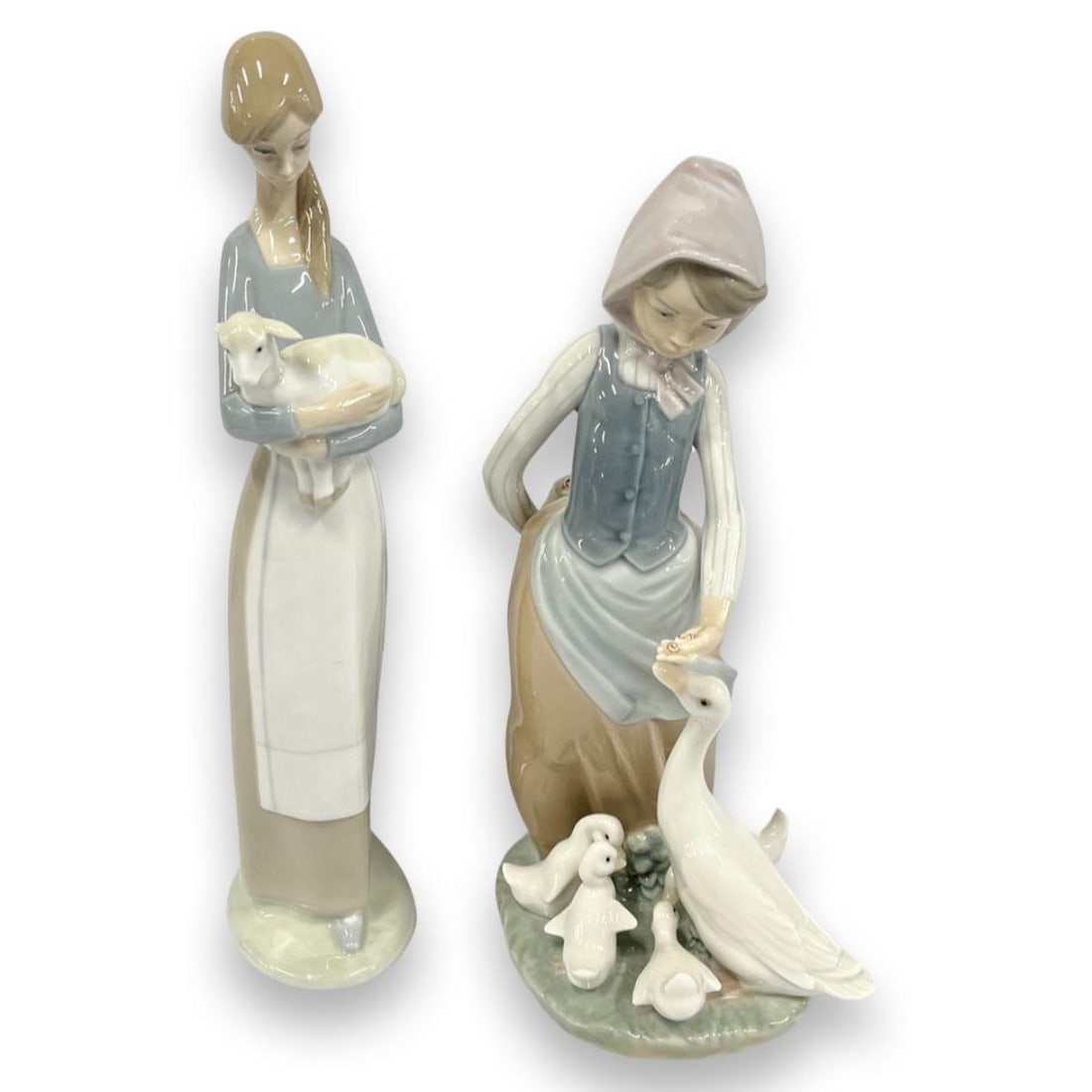 Pair of Lladro Porcelain Figurines: Pair of Lladro Porcelain Figurines includes #4505 Girl with Lamb & #1277 Snails for Ducks. Largest measures H: 10 1/2"