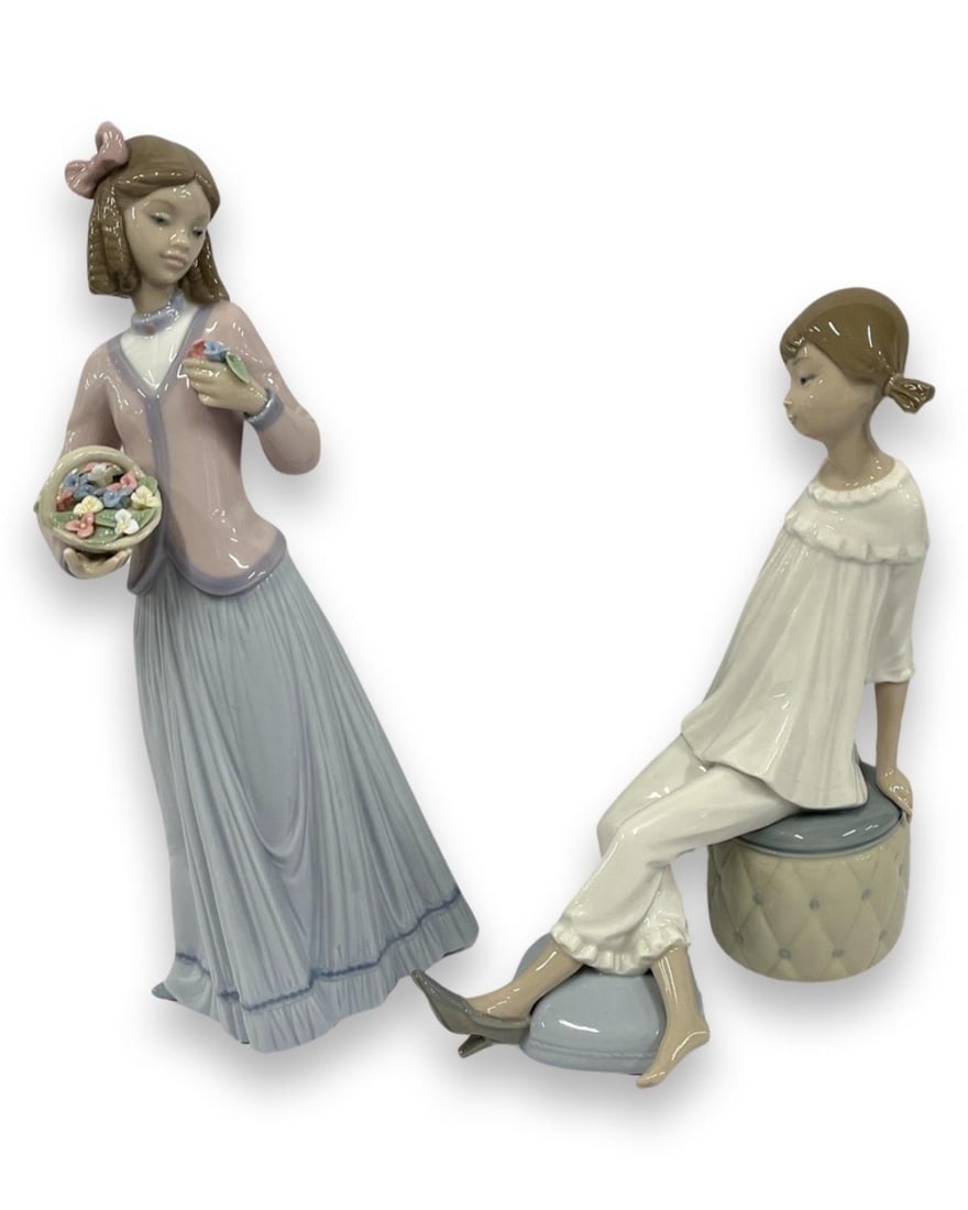 Pair of Lladro Porcelain Figurines: Pair of Lladro Porcelain Figurines includes #1084 Girl with Mother's Shoes & #7644 Innocence in Bloom. Largest measures H: 9 1/2"