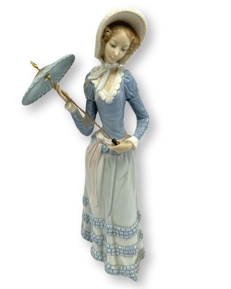 Lladro #4879 Lady with Parasol Porcelain Figure: Lladro #4879 Lady with Parasol Porcelain Figure measures H: 12"
