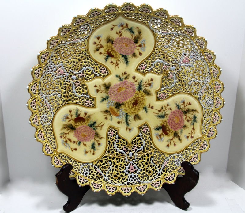 Antique Zsolnay Reticulated Jeweled Charger: Antique austrian-hungarian Zsolnay reticulated charger with scalloped edges and hand painted flowers on a yellowish background. 18 1/4" diameter x 2 1/2" highFor Domestic or International Shipping Quo
