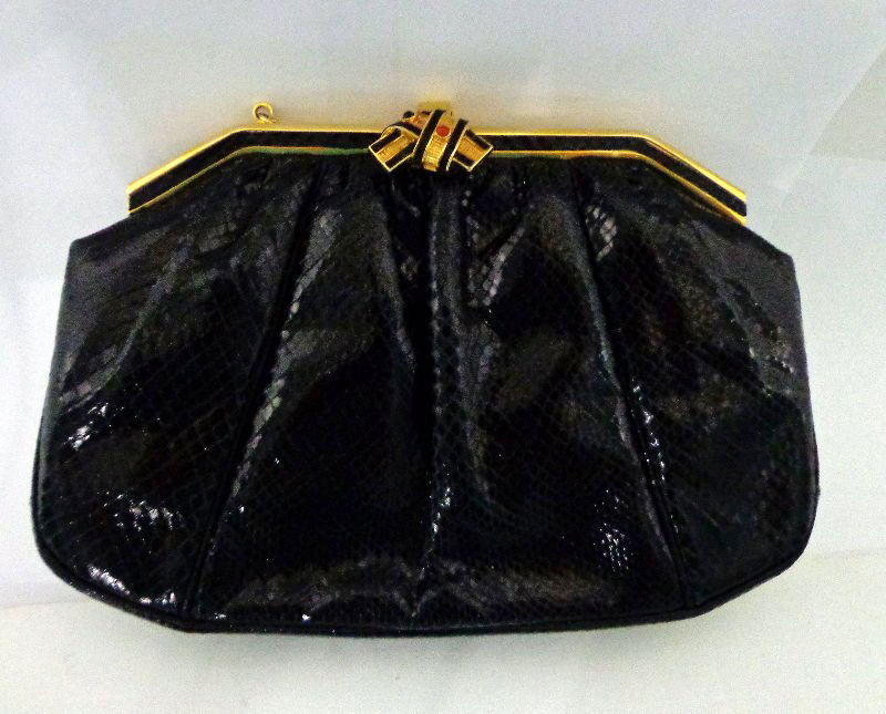 Judith Leiber Black Leather Purse: Judith Leiber black leather purse with a black and gilt clasp and strap. Measures 8 3/8" height x 5 7/8" wide. For Domestic or International Shipping Quotes Please Feel Call Ryan or Dave at Eagle Ship