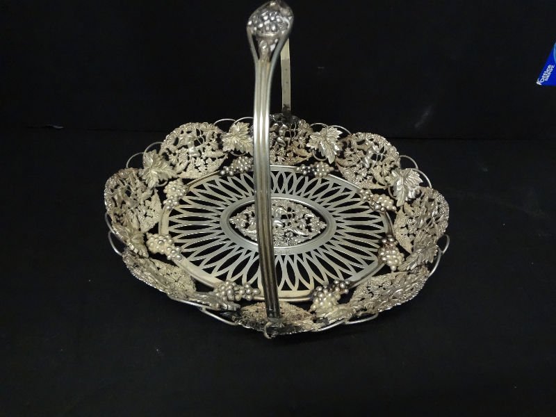 19th/20th Century Reticulated American Sterling Fr: 19th-20th century reticulated America sterling silver fruit basket. Depicts floral and fruit design with figure of cupid in the center shooting an arrow. J.M.K mono. Weighs 22 toz. Measures 7 1/2" hig