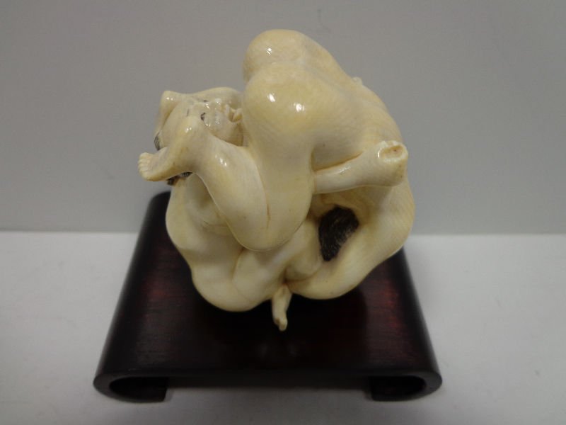 Japanese Ivory Erotic Two Figure Netsuke: Japanese hand carved ivory two figure netsuke depicting an erotic scene. Figures measures 2 1/2" x 2 1/4" on base measuring 3 3/8" x 2 1/2" wide x 3/4" high.