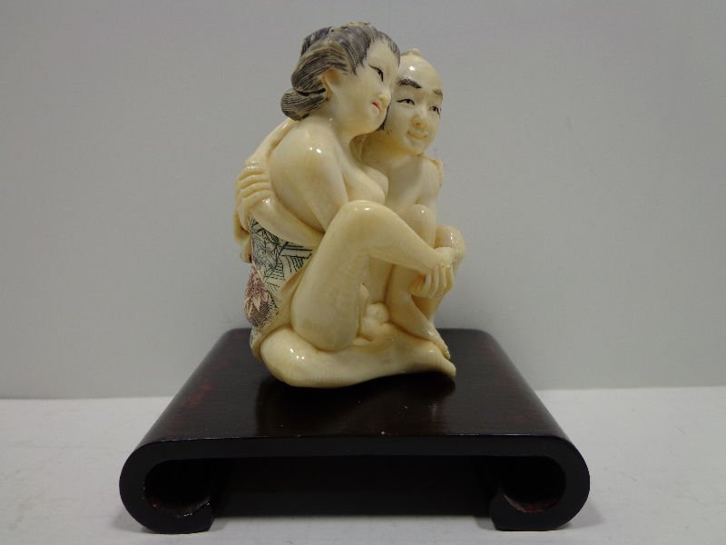 Japanese Hand Carved Erotic Netsuke Figural Scene: Japanese hand carved ivory two figure netsuke depicting an erotic scene. Figures measures 2 1/2" x 2 1/4" on base measuring 3 1/2" x 2" wide x 3/4" high.